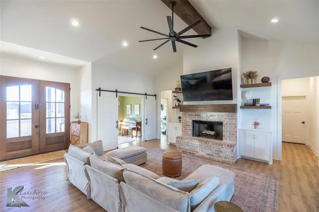 a living room with furniture a fireplace and a flat screen tv
