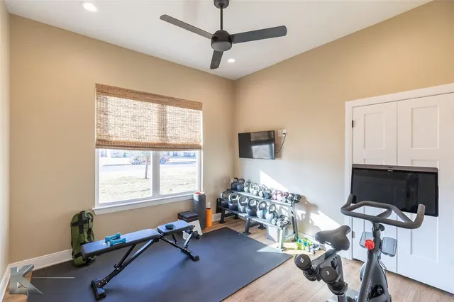 a living room with furniture gym equipment and a flat screen tv