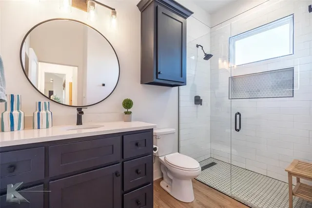 a bathroom with a toilet a sink and mirror
