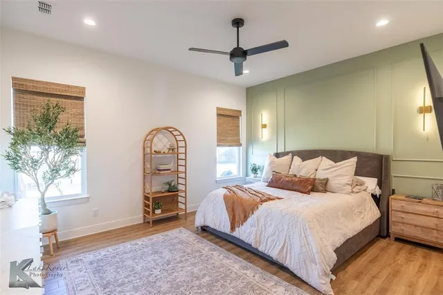 a bedroom with a bed and a chandelier