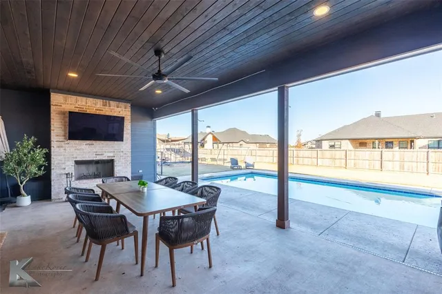 a view of swimming pool with outdoor seating and plants