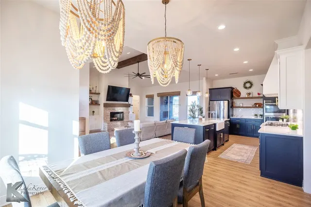 a large kitchen with a table and chairs