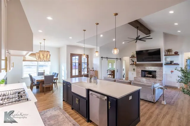 a kitchen with a stove a refrigerator and a fireplace