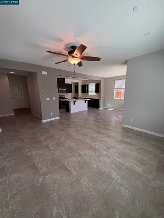 a kitchen with kitchen island granite countertop a sink a stove and a refrigerator