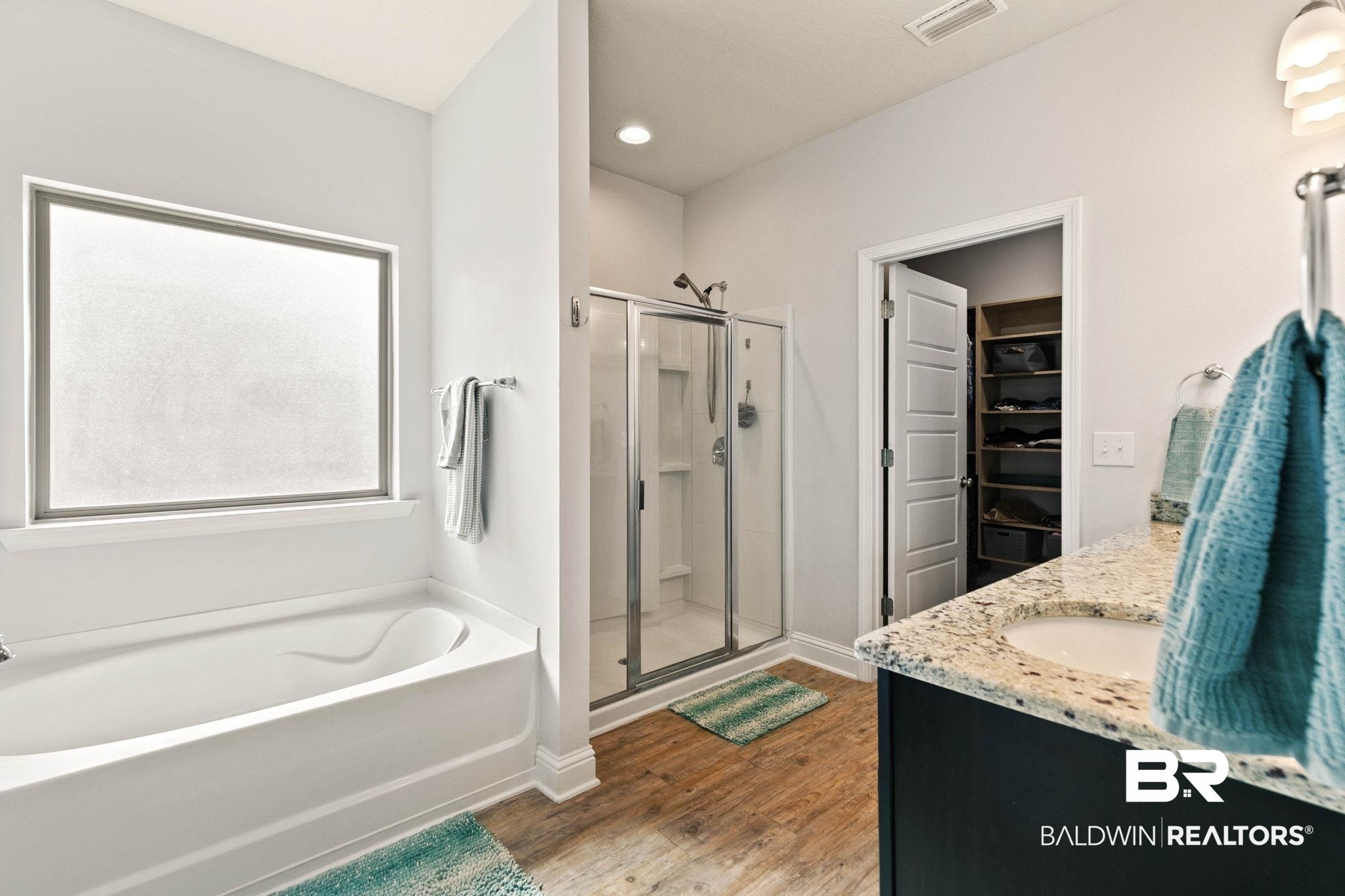 31350 Hoot Owl Road Daphne, AL 36527 - Photo 27 of 94 Full bath featuring vanity, a shower stall, a spacious closet, a bath, and light wood-style floors
