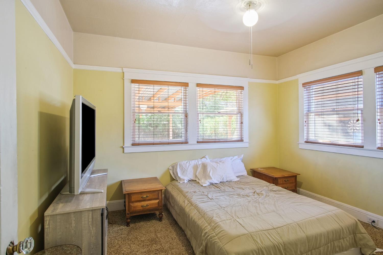 930 West Harding Way Stockton, CA 95203 - Photo 13 of 22 a bedroom with a bed and a flat screen tv