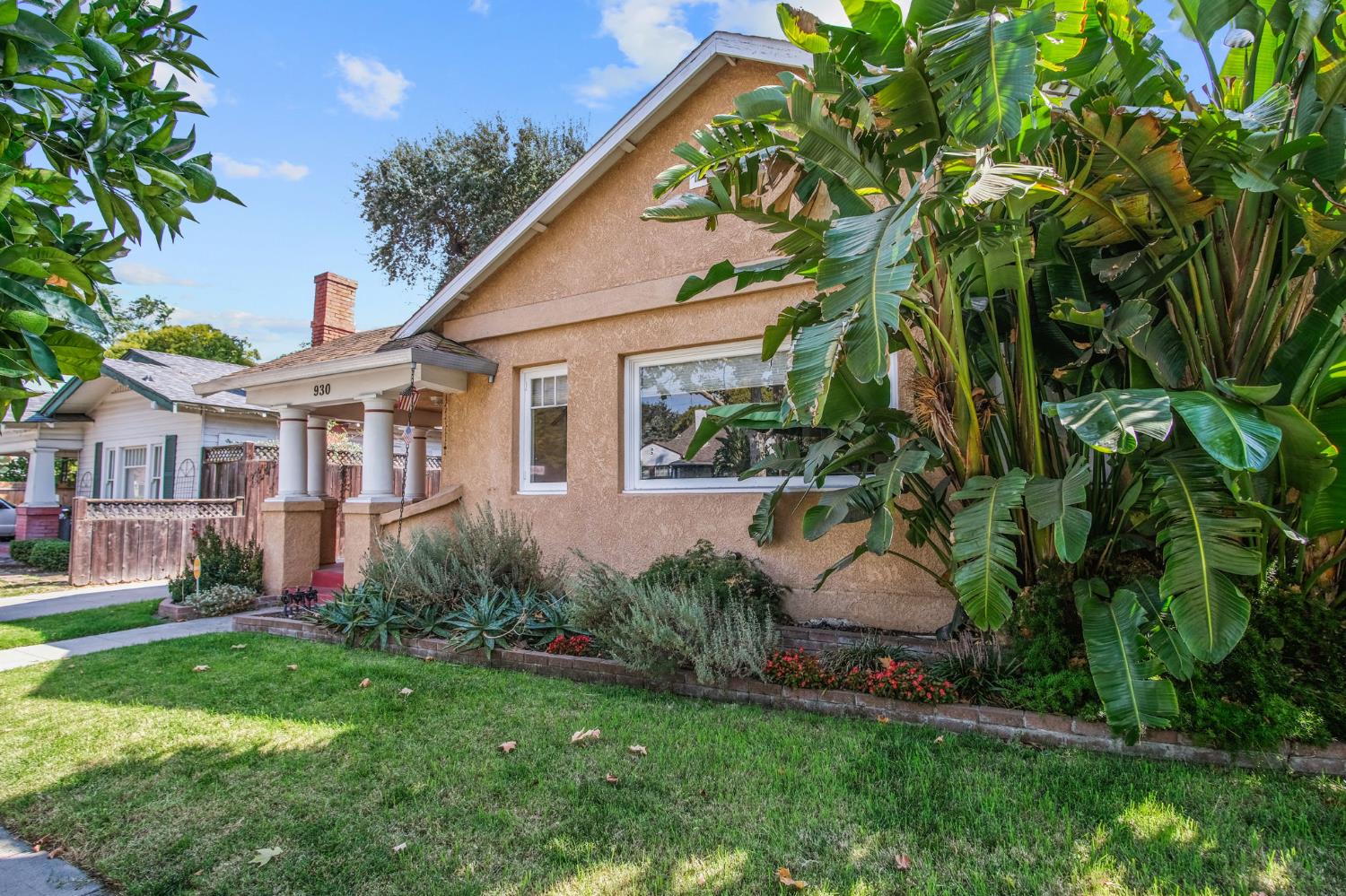 930 West Harding Way Stockton, CA 95203 - Photo 2 of 22 a front view of a house with a garden and plants