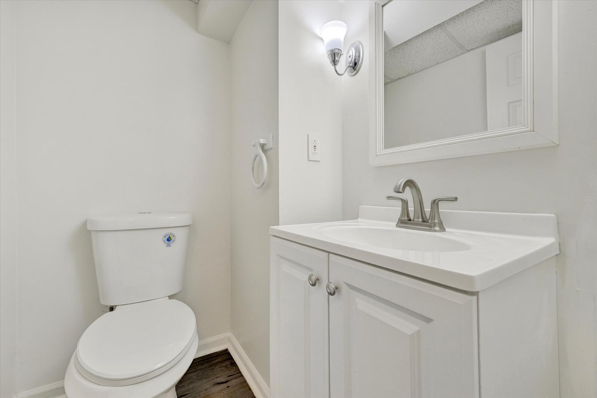 7007 Bank Street Baltimore, MD 21224 - Photo 13 of 17 a bathroom with a toilet sink and mirror