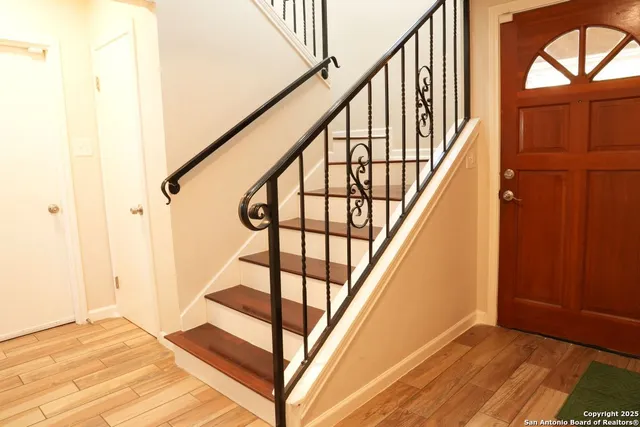 a view of entryway with wooden floor and stairs