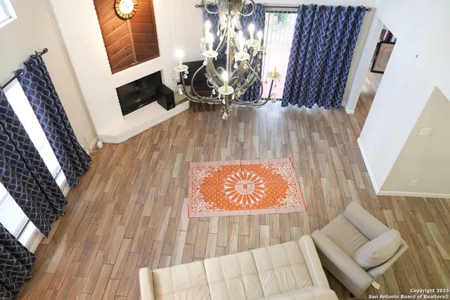 a view of living room with a fireplace and wooden floor