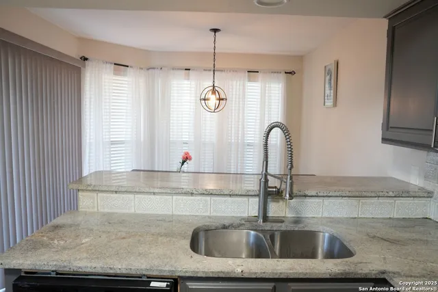 a kitchen with a sink and a window