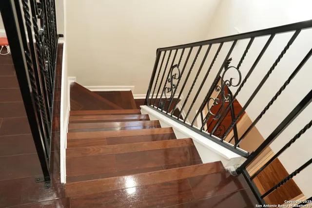 a view of staircase with white walls and a window