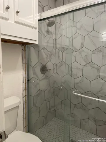 a bathroom with a toilet and a shower