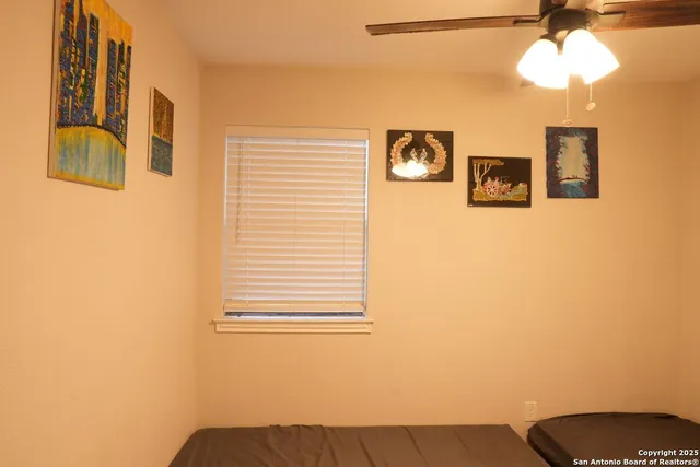a view of a bedroom with a bed and a chandelier
