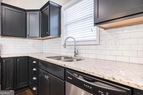 a kitchen with a stove microwave and sink