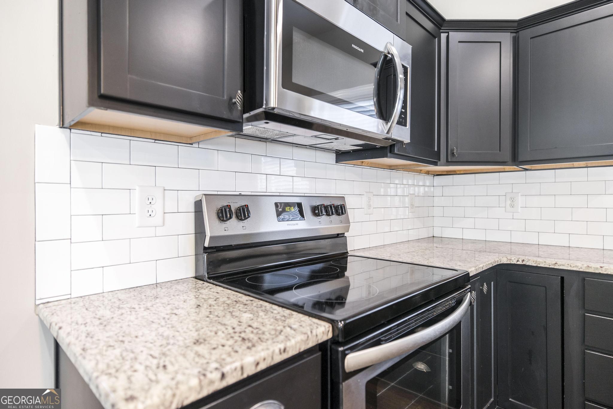 104 Goldenrod Trail Perry, GA 31069 - Photo 13 of 35 a kitchen with a stove microwave and sink