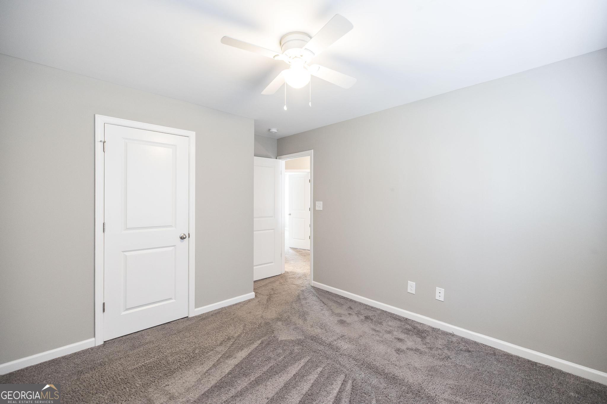 104 Goldenrod Trail Perry, GA 31069 - Photo 20 of 35 a view of an empty room with a ceiling fan