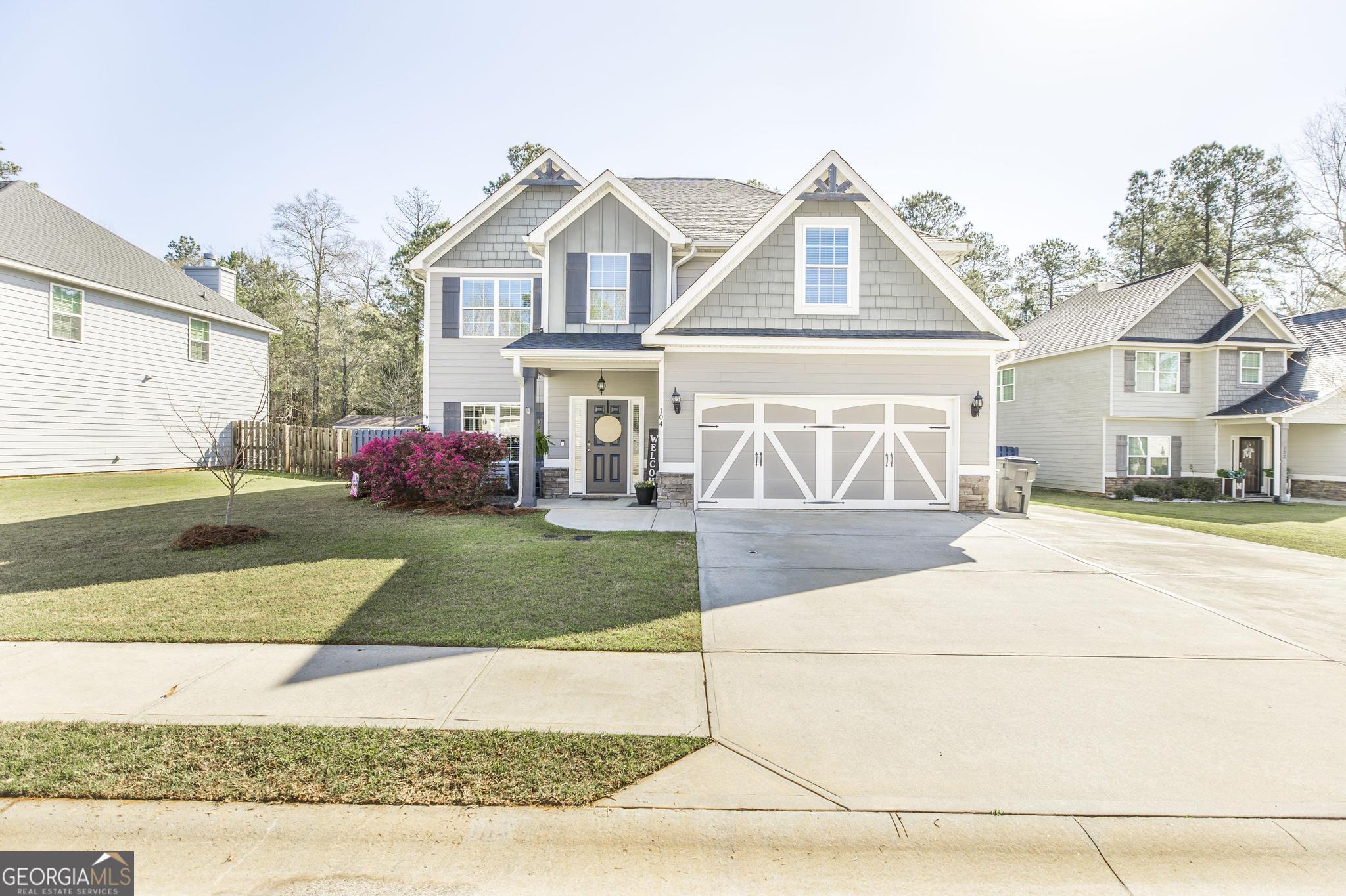 104 Goldenrod Trail Perry, GA 31069 - Photo 2 of 35 a front view of a house with a yard and garage