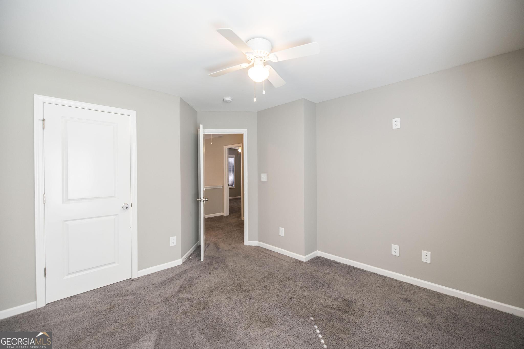 104 Goldenrod Trail Perry, GA 31069 - Photo 25 of 35 an empty room with closet and a ceiling fan