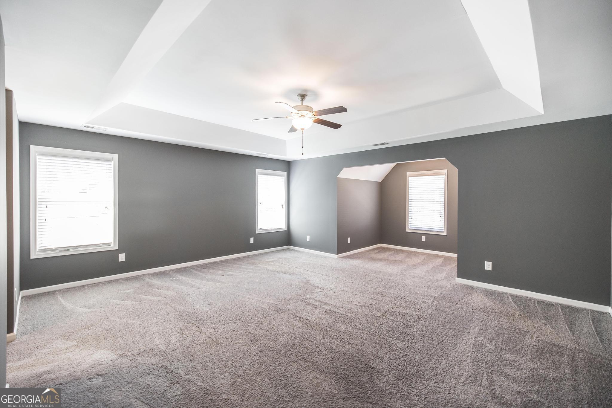104 Goldenrod Trail Perry, GA 31069 - Photo 26 of 35 an empty room with windows and ceiling fan