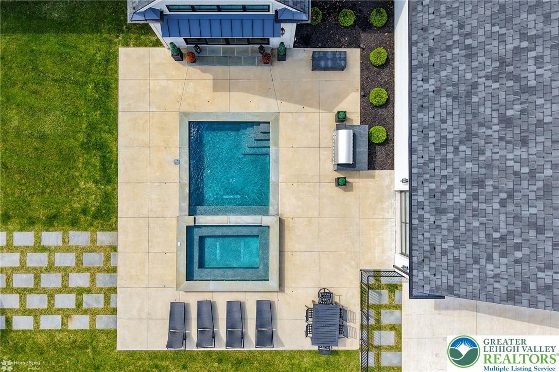 4850 West Hopewell Road Center Valley, PA 18034 - Photo 32 of 96 An aerial perspective reveals a luxurious outdoor oasis, complete with a sparkling pool and inviting spa.