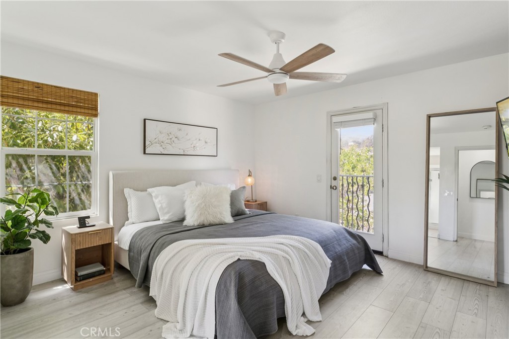 4155 Windspring Street Corona, CA 92883 - Photo 22 of 38 a bedroom with a bed and a potted plant