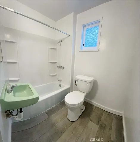 a bathroom with a sink toilet and a bathtub