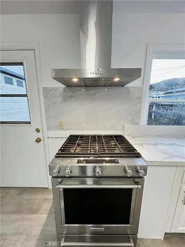 a stove top oven sitting inside of a kitchen