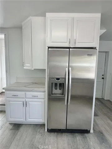 a kitchen with cabinets and stainless steel appliances
