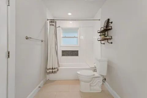 a bathroom with a toilet sink and shower