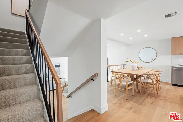 a kitchen with a table chairs sink and cabinets