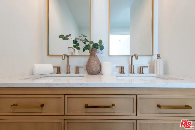 a bedroom with a bed and a potted plant