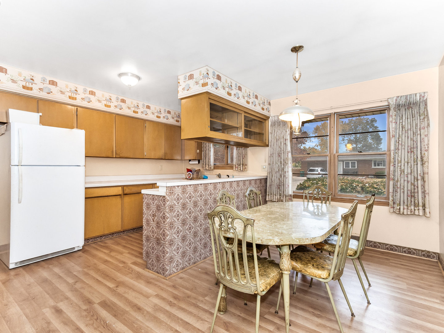 913 Westminster Road Joliet, IL 60435 - Photo 6 of 24 a kitchen with a table chairs and a refrigerator