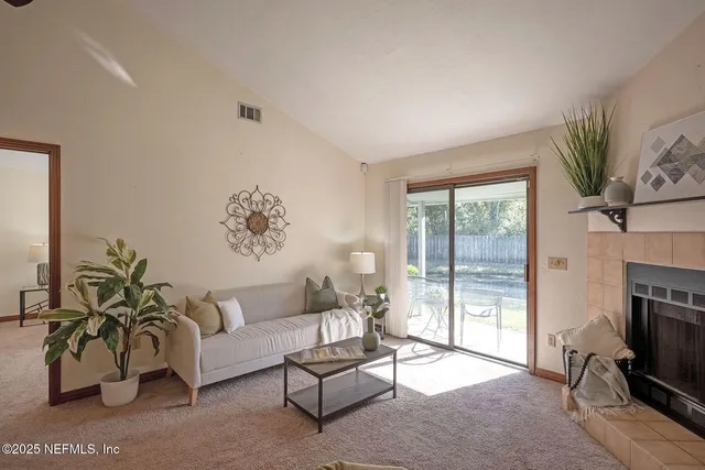 a living room with furniture window and a fireplace
