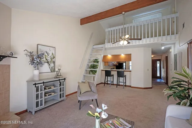 a view of a livingroom with furniture and a floor to ceiling window