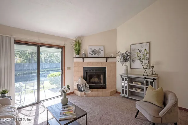 a living room with furniture and a fireplace