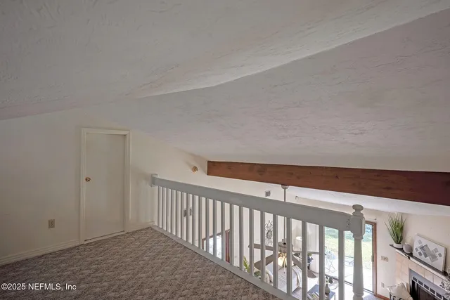 a view of staircase with rug