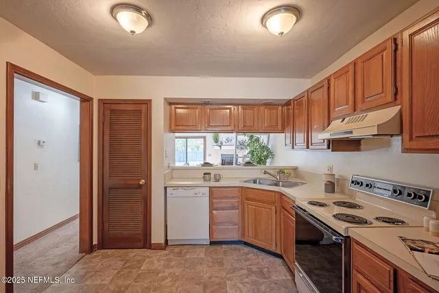 a kitchen with a sink stove and refrigerator