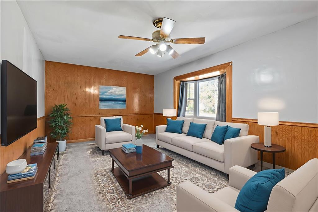 197 Douglass Road Beaver Falls, PA 15010 - Photo 12 of 33 a living room with furniture flat screen tv and a large window