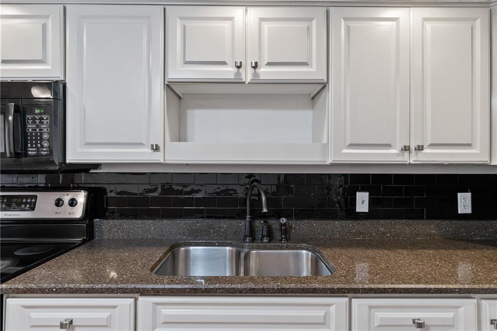 197 Douglass Road Beaver Falls, PA 15010 - Photo 15 of 33 a kitchen with granite countertop a sink and cabinets