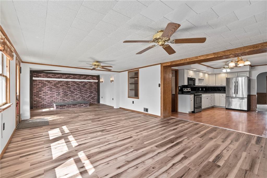 197 Douglass Road Beaver Falls, PA 15010 - Photo 20 of 33 a view of empty room with wooden floor and a ceiling fan