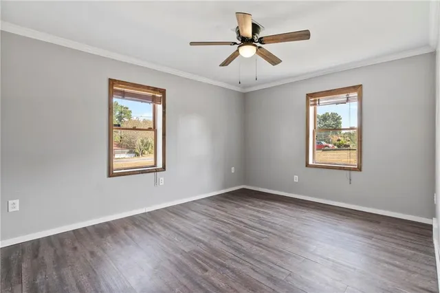 a bathroom with a granite countertop sink a mirror and a bathtub