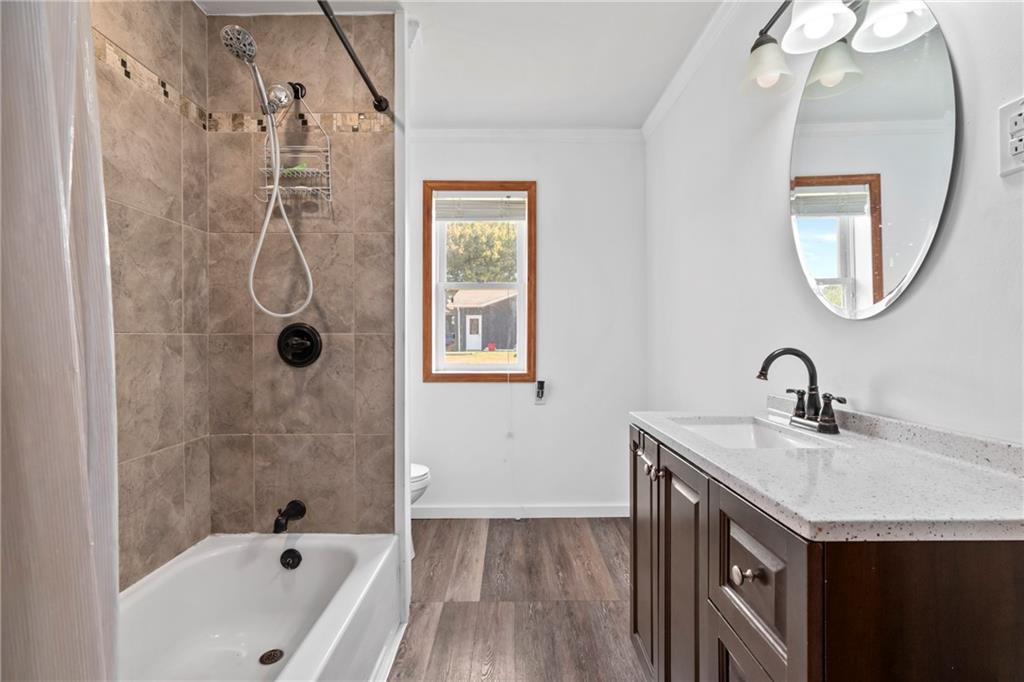 197 Douglass Road Beaver Falls, PA 15010 - Photo 25 of 33 a bathroom with a granite countertop sink a mirror and a bathtub