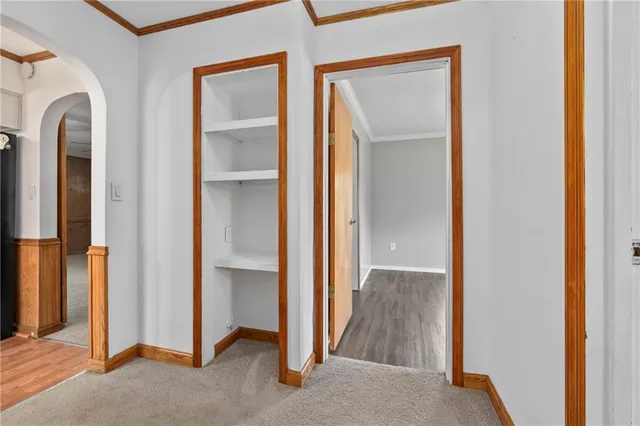 a view of a hallway with a chandelier fan