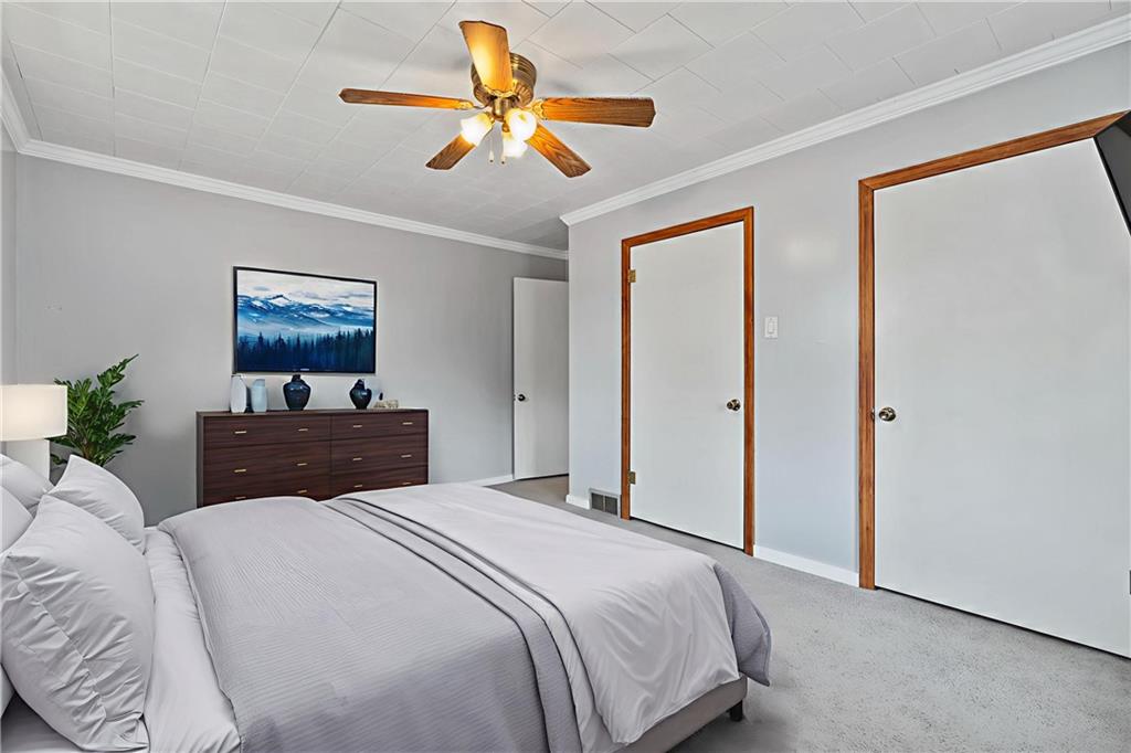 197 Douglass Road Beaver Falls, PA 15010 - Photo 31 of 33 a bedroom with a large bed a chandelier and a dresser