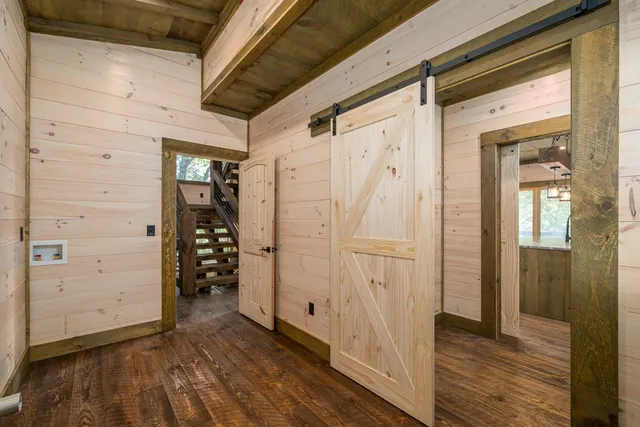 a view of an empty room with a fireplace and a window