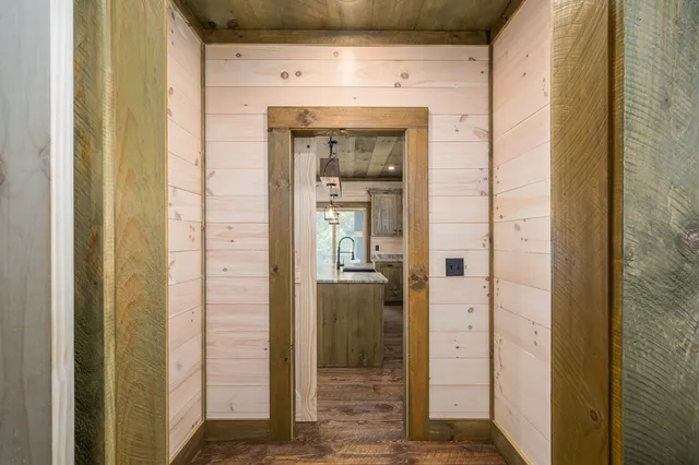 a view of a livingroom with wooden floor and a fireplace