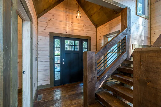 a view of a livingroom with wooden floor a fireplace and window
