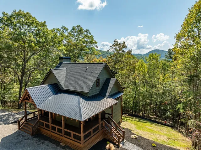 a view of wooden house with a yard