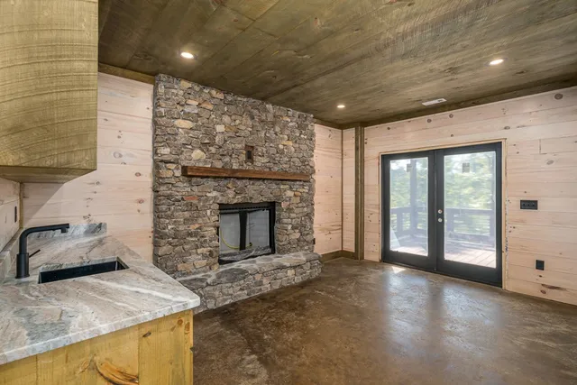 a bathroom with a granite countertop sink a toilet and shower